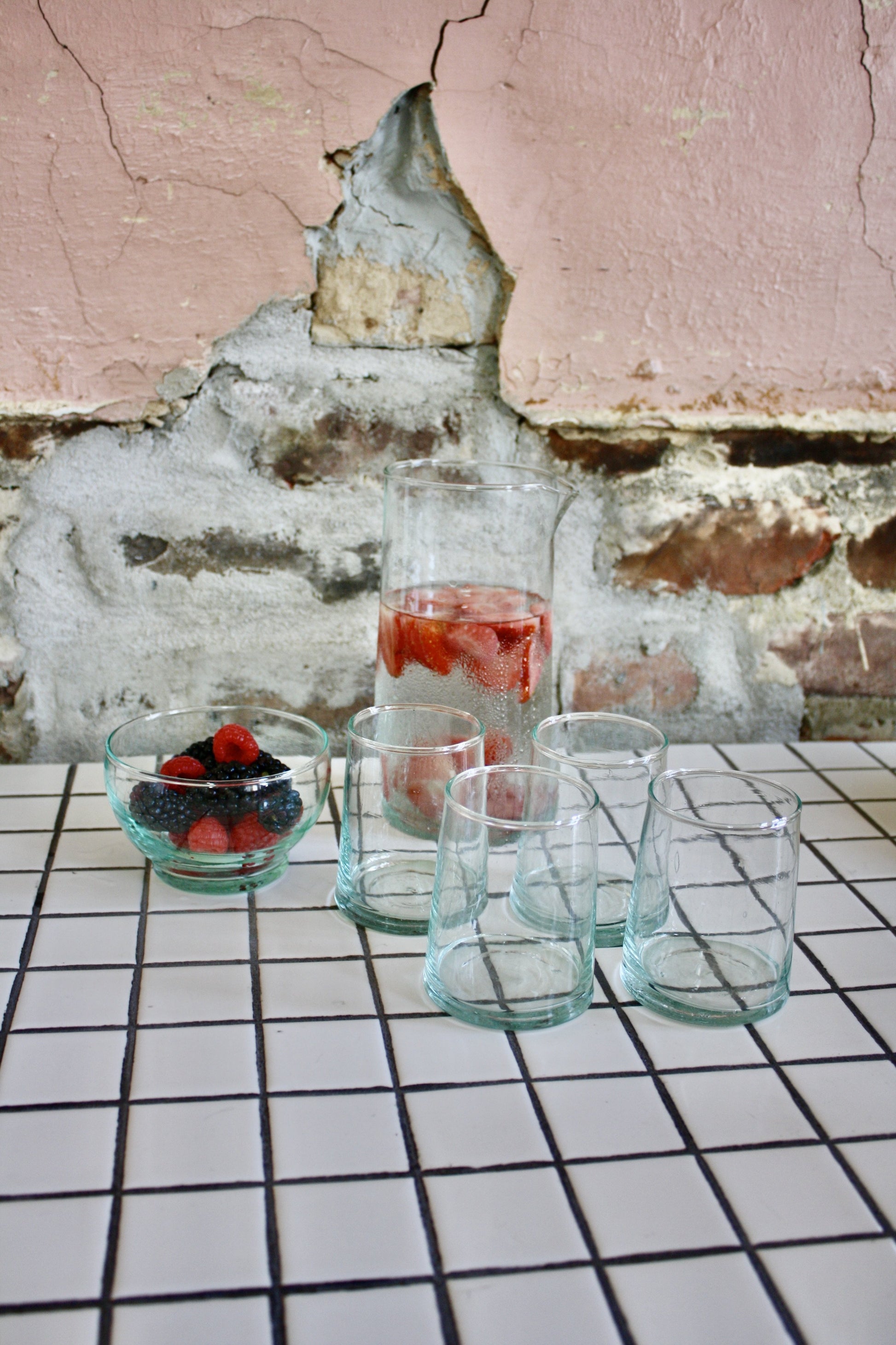 Set of 24 handblown glasses handmade in Morocco from recycled glass by artisans using traditional techniques since 1946.