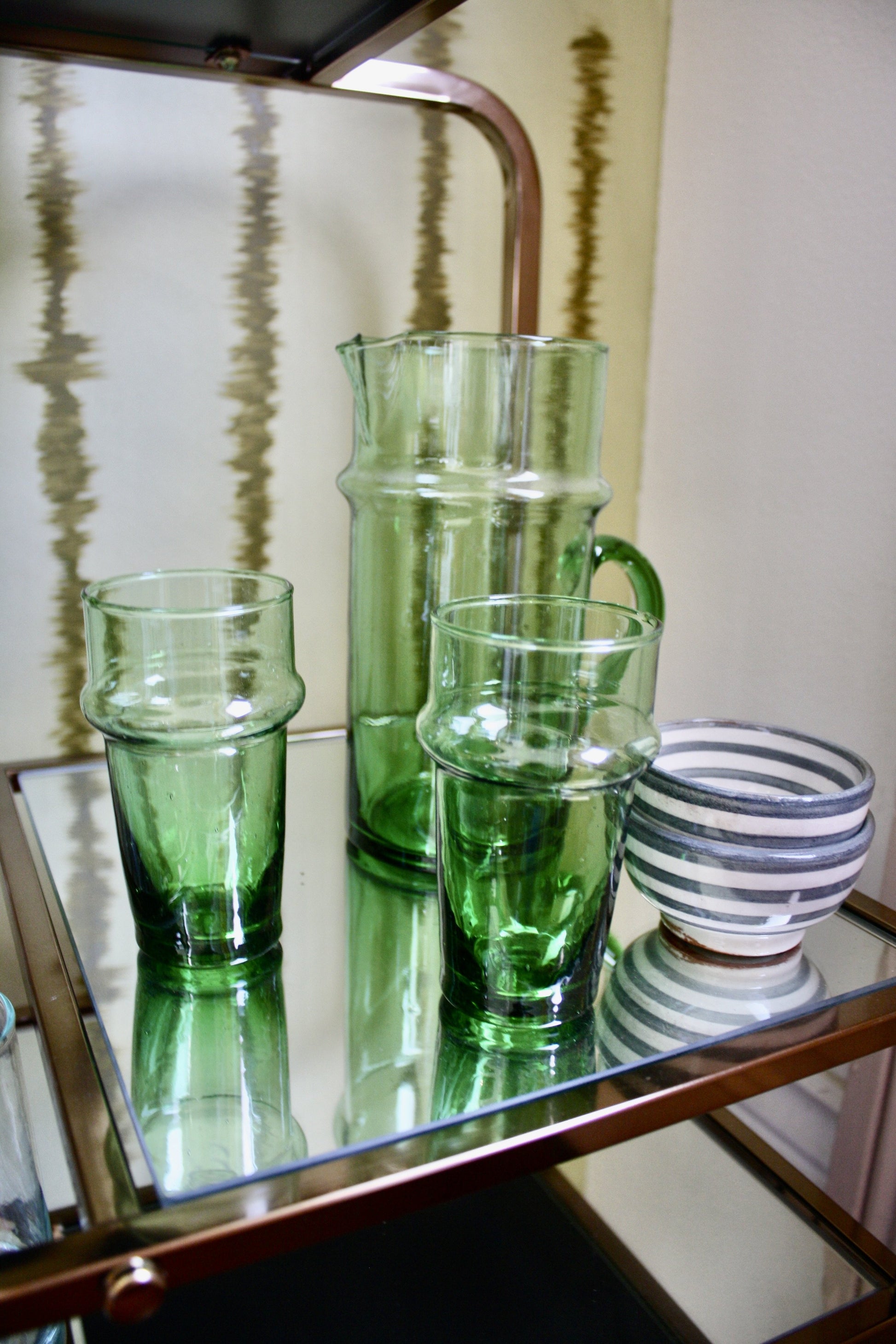 Set of 12 green handblown glasses handmade in Morocco from recycled glass by artisans using traditional techniques since 1946.