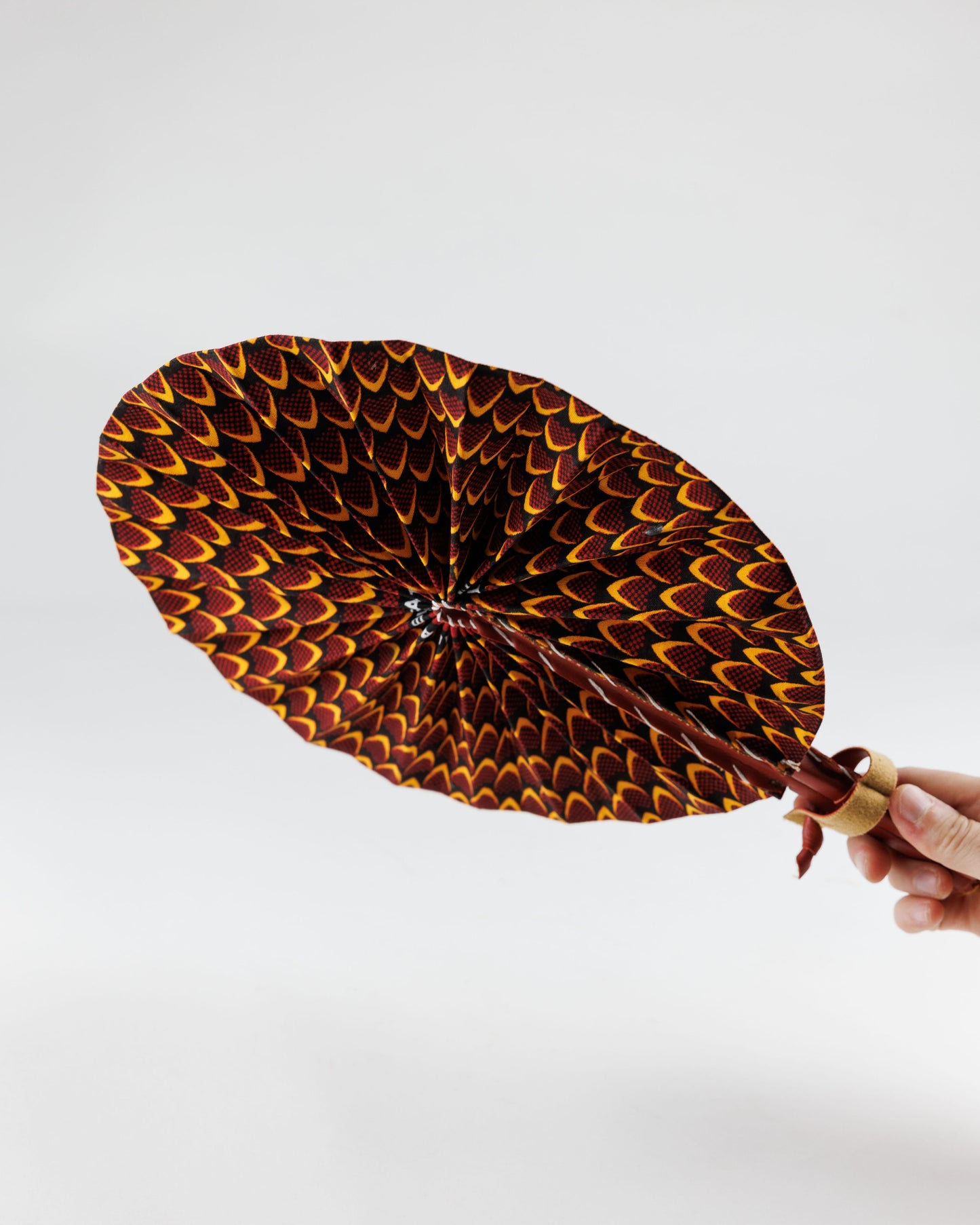 Fan- Collapses for easy storage, made from African wax fabric