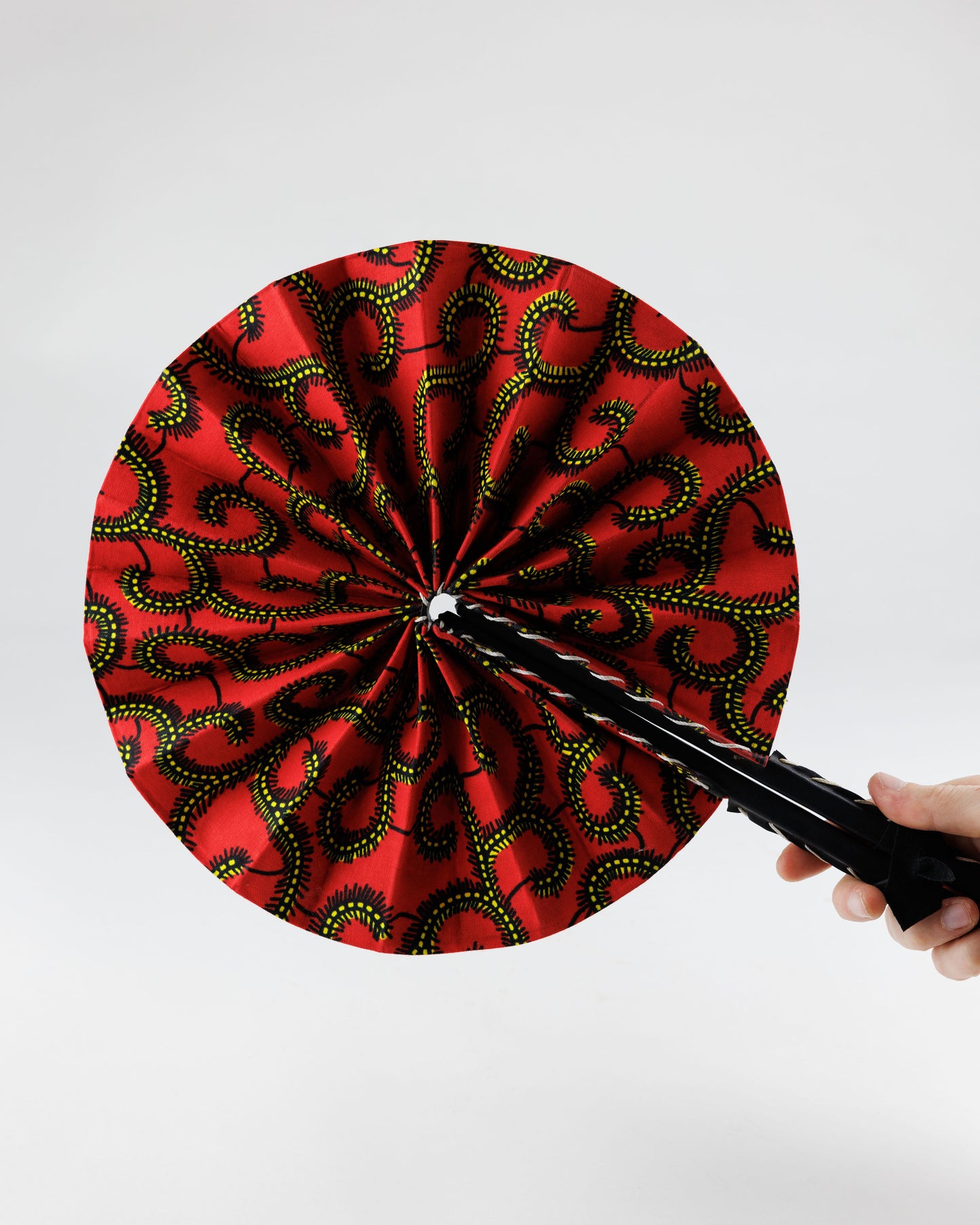 Fan- Collapses for easy storage, made from African wax fabric