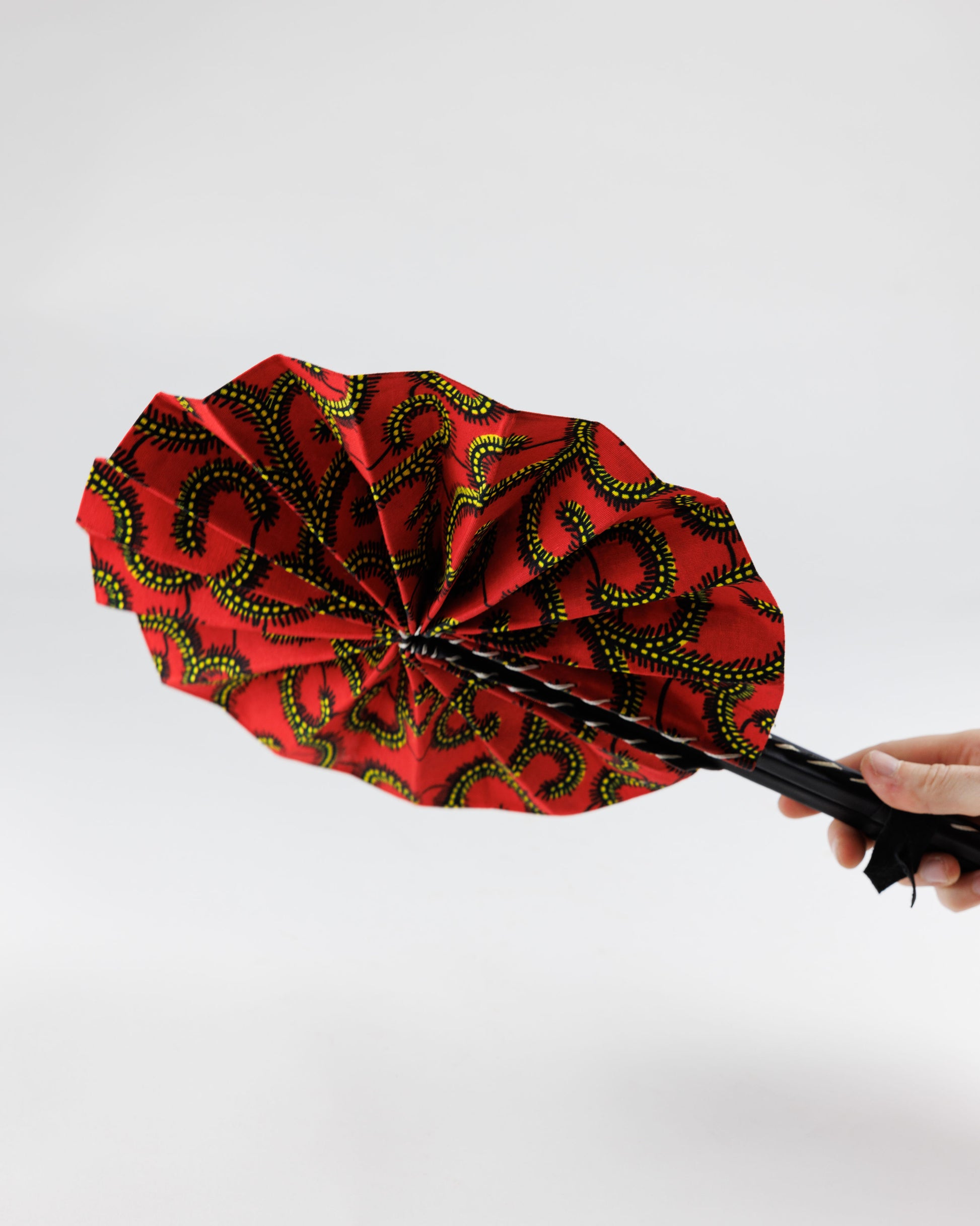 Fan- Collapses for easy storage, made from African wax fabric