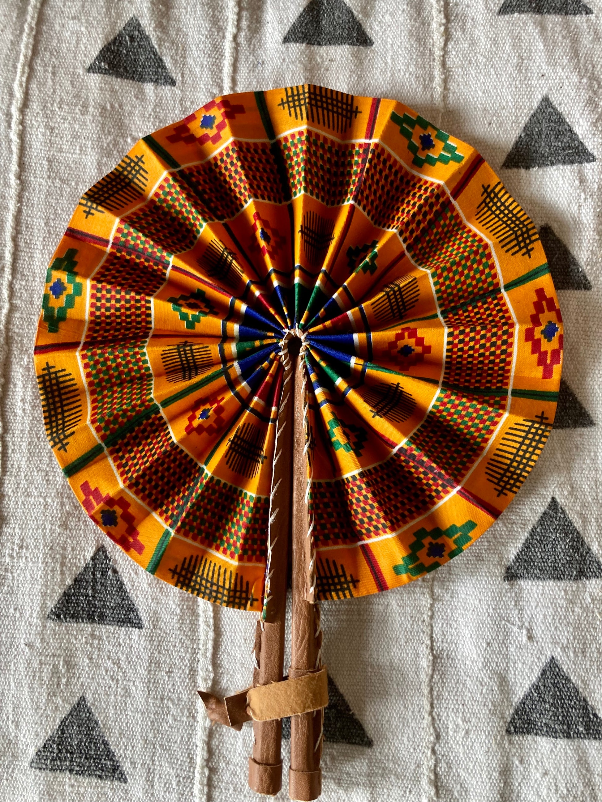 Fan- Collapses for easy storage, made from African wax fabric