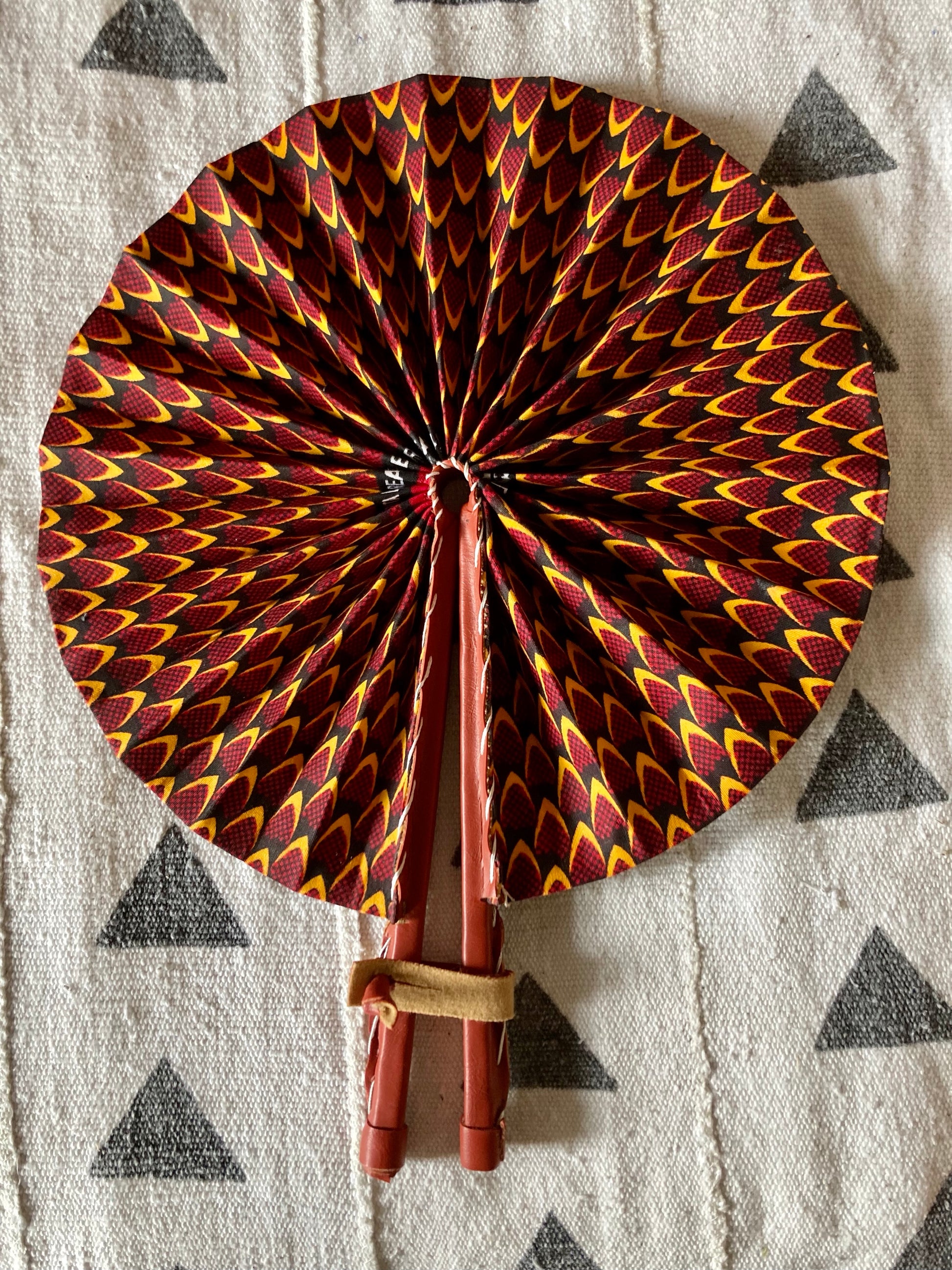 Fan- Collapses for easy storage, made from African wax fabric